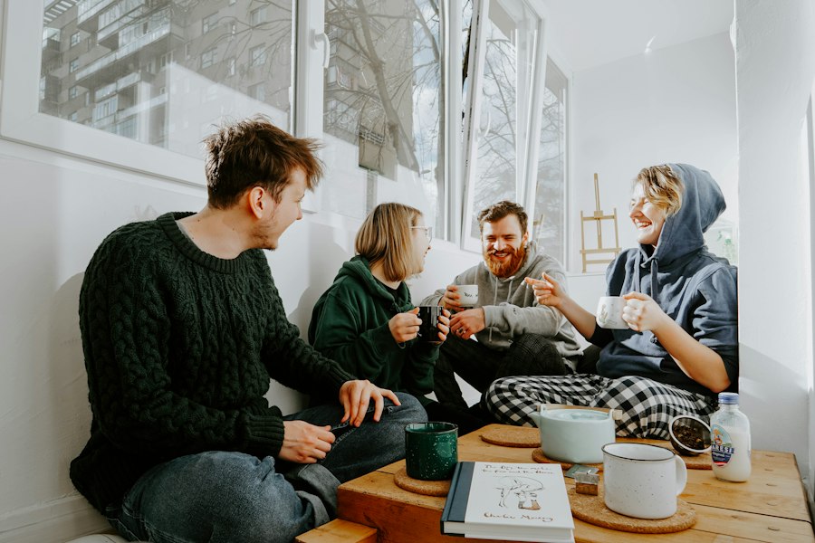 A small group chatting over coffee around a wooden table